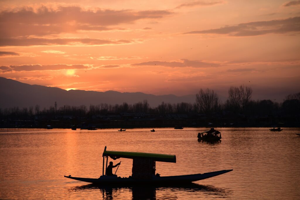 Travelers enjoying a shikara ride on Dal Lake "Kashmir tour booking services